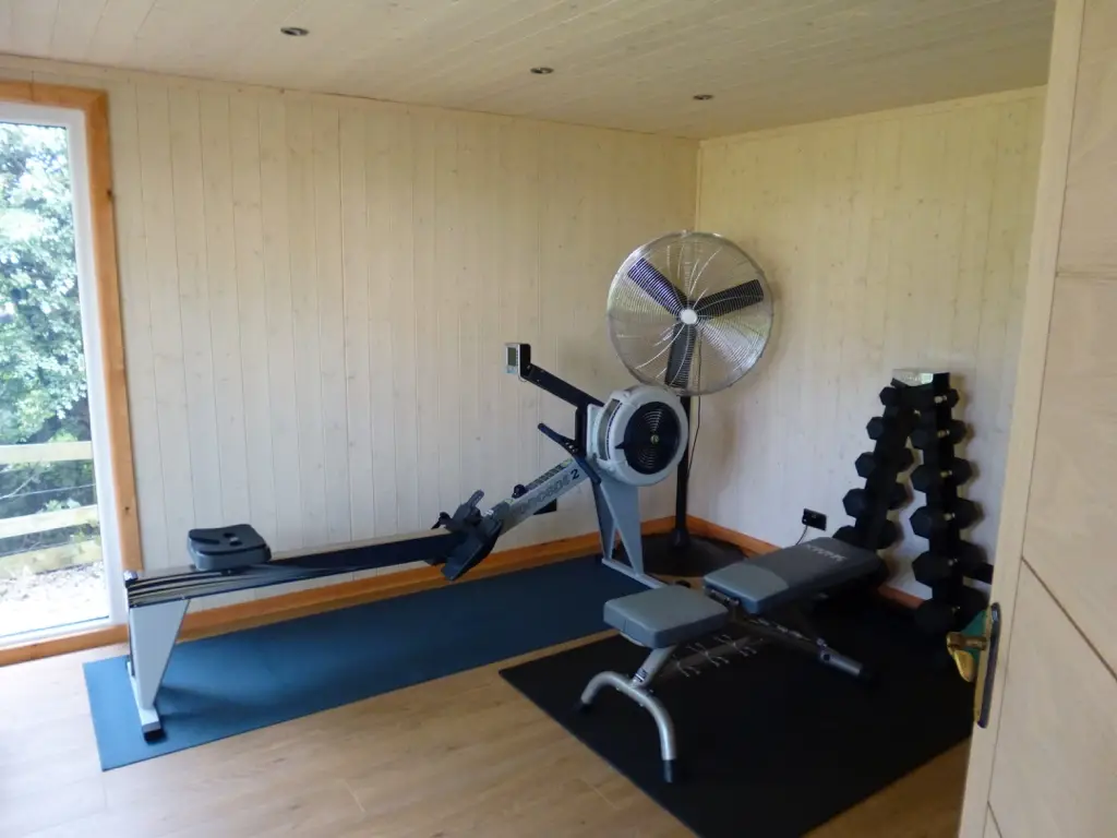 western red cedar home gym interior photo THIS IS A BESPOKE SUMMERHOUSE
