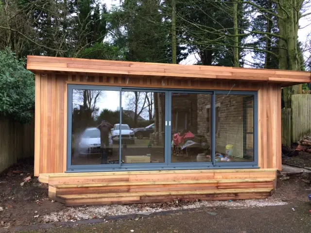 this is a Cedar Gym with light grey upvc windows and doors