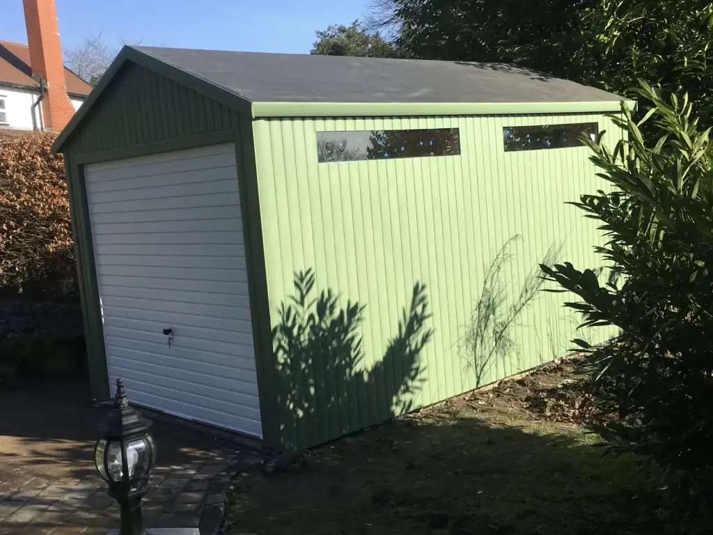 Lancashire Summerhouses- this is a single timber garage painted in green with a white up and over door