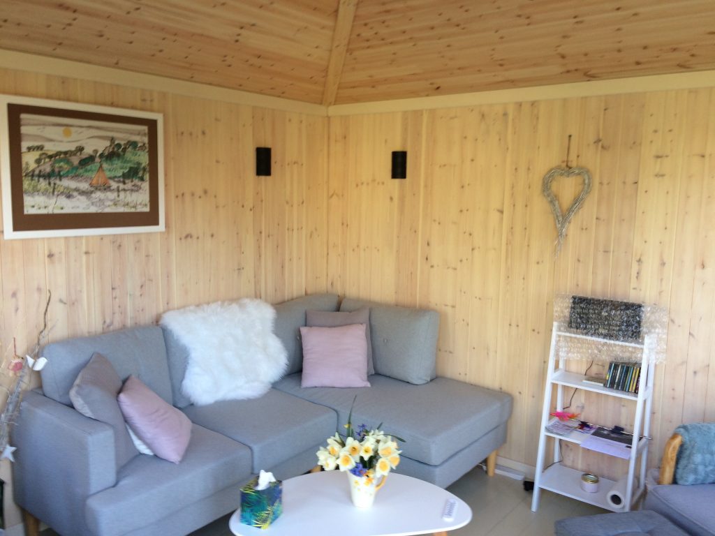 This is an interior view of a corner summerhouse with a vaulted ceiling